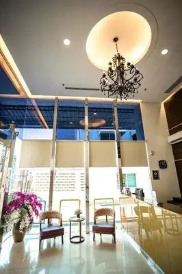 a lobby with chairs and a chandelier at PP Hotel Penang in George Town