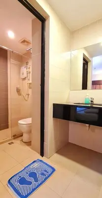 a bathroom with a shower and a sink and a toilet at PP Hotel Penang in George Town