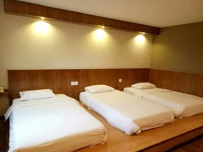 two beds in a hotel room with white sheets at PP Hotel Penang in George Town