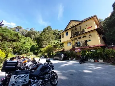 a group of motorcycles parked in front of a building at Highlanders Garden Guesthouse at Arundina Cameron Highlands in Cameron Highlands