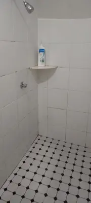 a bathroom with a black and white tiled floor at D'Mudah Motel & Homestay in Kulim
