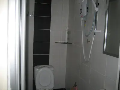 a bathroom with a shower and a toilet at D'Mudah Motel & Homestay in Kulim
