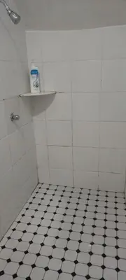 a bathroom with a black and white tiled floor at D'Mudah Motel & Homestay in Kulim