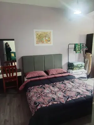 a bedroom with a bed with a rug on it at Cosy Homestay Tanah Rata in Tanah Rata