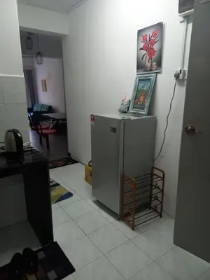 a room with a refrigerator and a picture on the wall at Cosy Homestay Tanah Rata in Tanah Rata