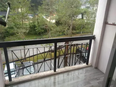 a balcony with a view of a street at Cosy Homestay Tanah Rata in Tanah Rata