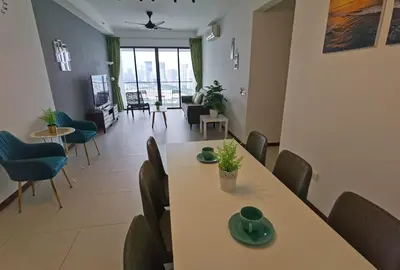 a dining room with a table and chairs at LM HomeyA 3 BdRm Coastline View condo for 4-14 Pax with Netflix & Coway Water Purifier in Tanjong Tokong