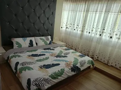 a bedroom with a bed with a headboard and a window at Best Sekinchan homestay in Sekincan