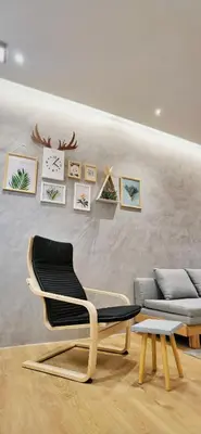 a living room with a chair and a couch at [Muji-Style Apartment] @ Cameron Jaya (3R2B) 8 pax in Tanah Rata