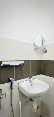 a bathroom with a sink and a mirror on the wall at [Muji-Style Apartment] @ Cameron Jaya (3R2B) 8 pax in Tanah Rata