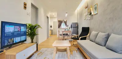 a living room with a couch and a tv at [Muji-Style Apartment] @ Cameron Jaya (3R2B) 8 pax in Tanah Rata