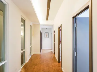a hallway in a house with white walls and wood floors at Joyful Guesthouse#IslandHosp in George Town