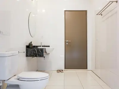a bathroom with a toilet and a sink and a shower at Joyful Guesthouse#IslandHosp in George Town