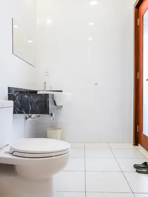 a white bathroom with a toilet and a sink at Joyful Guesthouse#IslandHosp in George Town