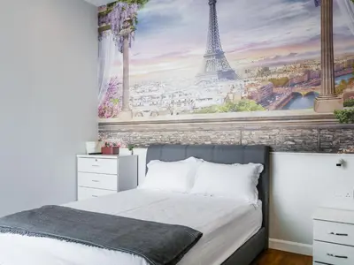 a bedroom with a mural of the eiffel tower at Joyful Guesthouse#IslandHosp in George Town
