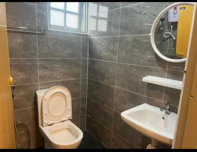 a bathroom with a toilet and a sink at ESM Hotel in Tanah Rata