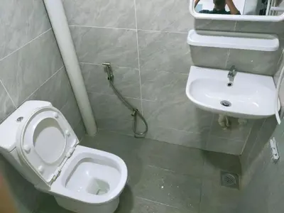 a bathroom with a toilet and a sink at ESM Hotel in Tanah Rata
