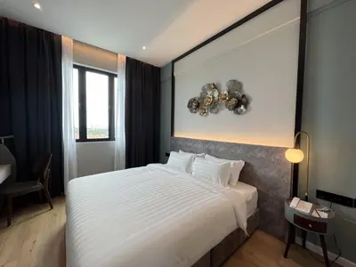a bedroom with a large bed in a room at FUHOTEL in Bukit Mertajam