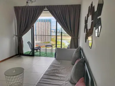 a living room with a bed and a large window at The Landmark Comfort Relax Spacious Sea View By IZ in Tanjong Tokong