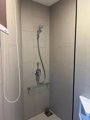 a shower with a shower head in a bathroom at The Landmark Comfort Relax Spacious Sea View By IZ in Tanjong Tokong