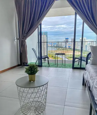 a living room with a couch and a table at The Landmark Comfort Relax Spacious Sea View By IZ in Tanjong Tokong