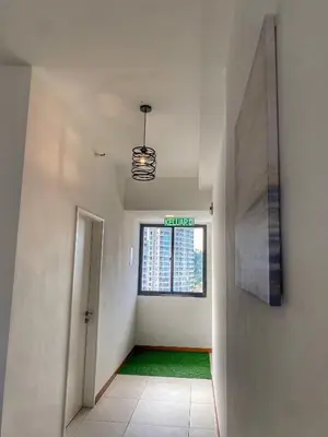 an empty hallway with a window in a building at The Landmark Comfort Relax Spacious Sea View By IZ in Tanjong Tokong