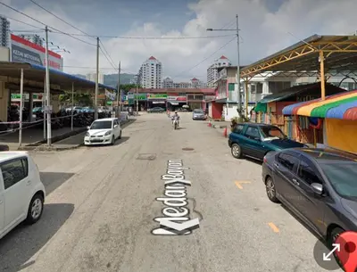 a street with cars parked on the side of the road at S PICE Arena Homestay in Bayan Lepas