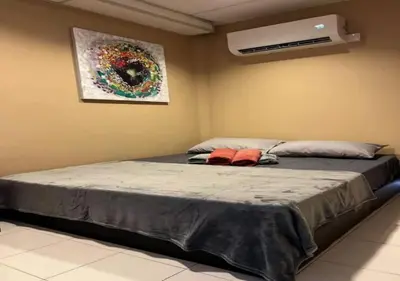 a bedroom with a bed and a air conditioner at CORAL BAY APARTMENT 3room (Ocean apartment) in Pangkor