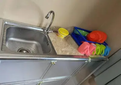 a kitchen sink with a faucet and some dishes at CORAL BAY APARTMENT 3room (Ocean apartment) in Pangkor