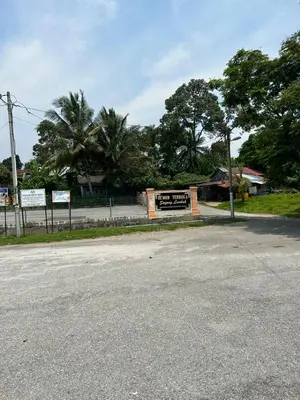 an empty street with a sign in the distance at Homestay Sham&Noi in Kuala Kangsar