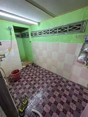a bathroom with a tiled floor in a room at Homestay Sham&Noi in Kuala Kangsar