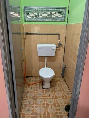 a bathroom with a toilet in a tiled room at Homestay Sham&Noi in Kuala Kangsar
