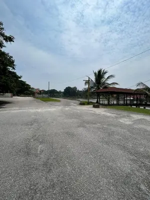 an empty road in front of a building with a pavilion at Homestay Sham&Noi in Kuala Kangsar