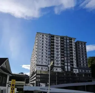 a tall building with a blue sky in the background at SA @ Cameron Emerald Avenue in Brinchang