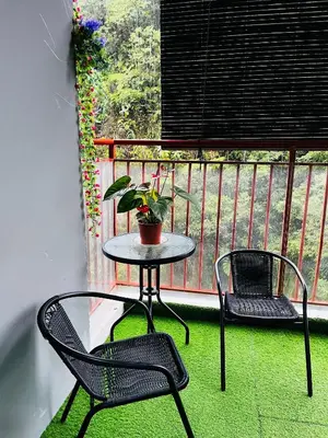 a table and two chairs on a balcony with a plant at SA @ Cameron Emerald Avenue in Brinchang