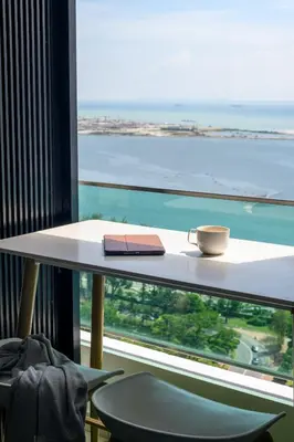 a table with a book and a cup on a window at 2R1B/Seaview Garden/1~8pax/Gurney/Mansion One in George Town