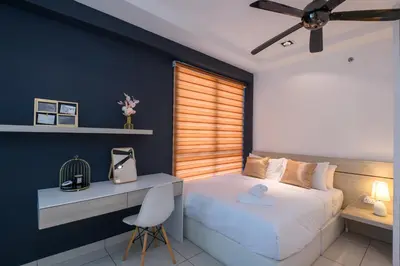 a bedroom with a bed and a desk and a chair at 2R1B/Seaview Garden/1~8pax/Gurney/Mansion One in George Town