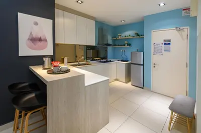 a kitchen with white cabinets and blue walls at 2R1B/Seaview Garden/1~8pax/Gurney/Mansion One in George Town