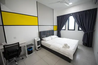 a bedroom with a bed and a desk and a computer at De Luma - Meritus in Perai