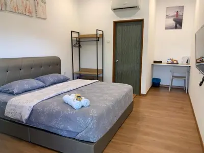 a bedroom with a bed with two teddy bears on it at Raintown Cottage in Taiping