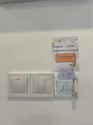 a white wall with a bunch of signs on it at Raintown Cottage in Taiping