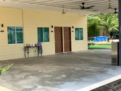 a front porch of a house with a patio at Raintown Cottage in Taiping