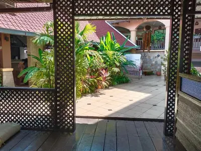 an open door to a courtyard with plants at D'Feringghi Hotel in Batu Ferringhi
