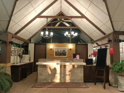 a restaurant with a counter in the middle of a building at D'Feringghi Hotel in Batu Ferringhi