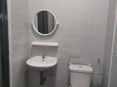 a bathroom with a sink and a toilet and a mirror at Grey Fantasy Homes#Sunway Water Theme Park in Ipoh