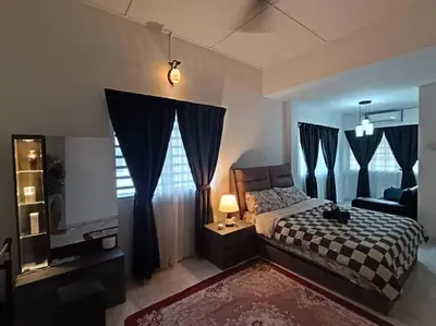 a bedroom with a bed and a tv and curtains at Grey Fantasy Homes#Sunway Water Theme Park in Ipoh