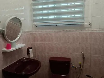 a bathroom with a sink and a toilet and a mirror at Grey Fantasy Homes#Sunway Water Theme Park in Ipoh
