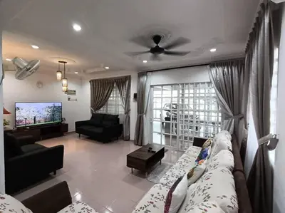 a living room with a couch and a tv at Grey Fantasy Homes#Sunway Water Theme Park in Ipoh