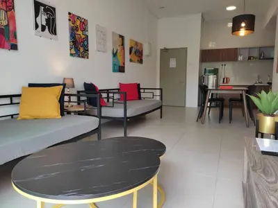 a living room with couches and a table at The Gallery Camerons, cosy for the whole family in Brinchang