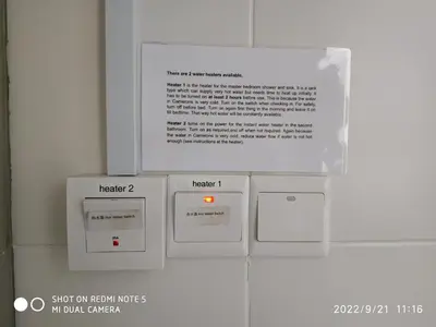 a group of boxes on a wall with a sign at The Gallery Camerons, cosy for the whole family in Brinchang